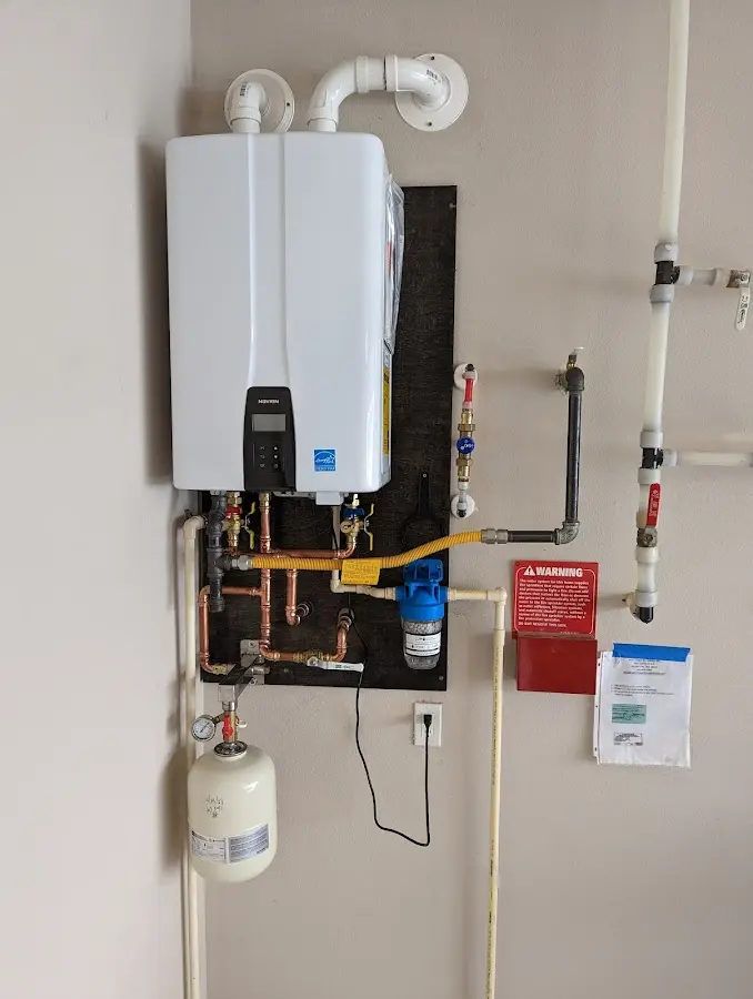 Professional plumber installing copper piping in a Four Corners home